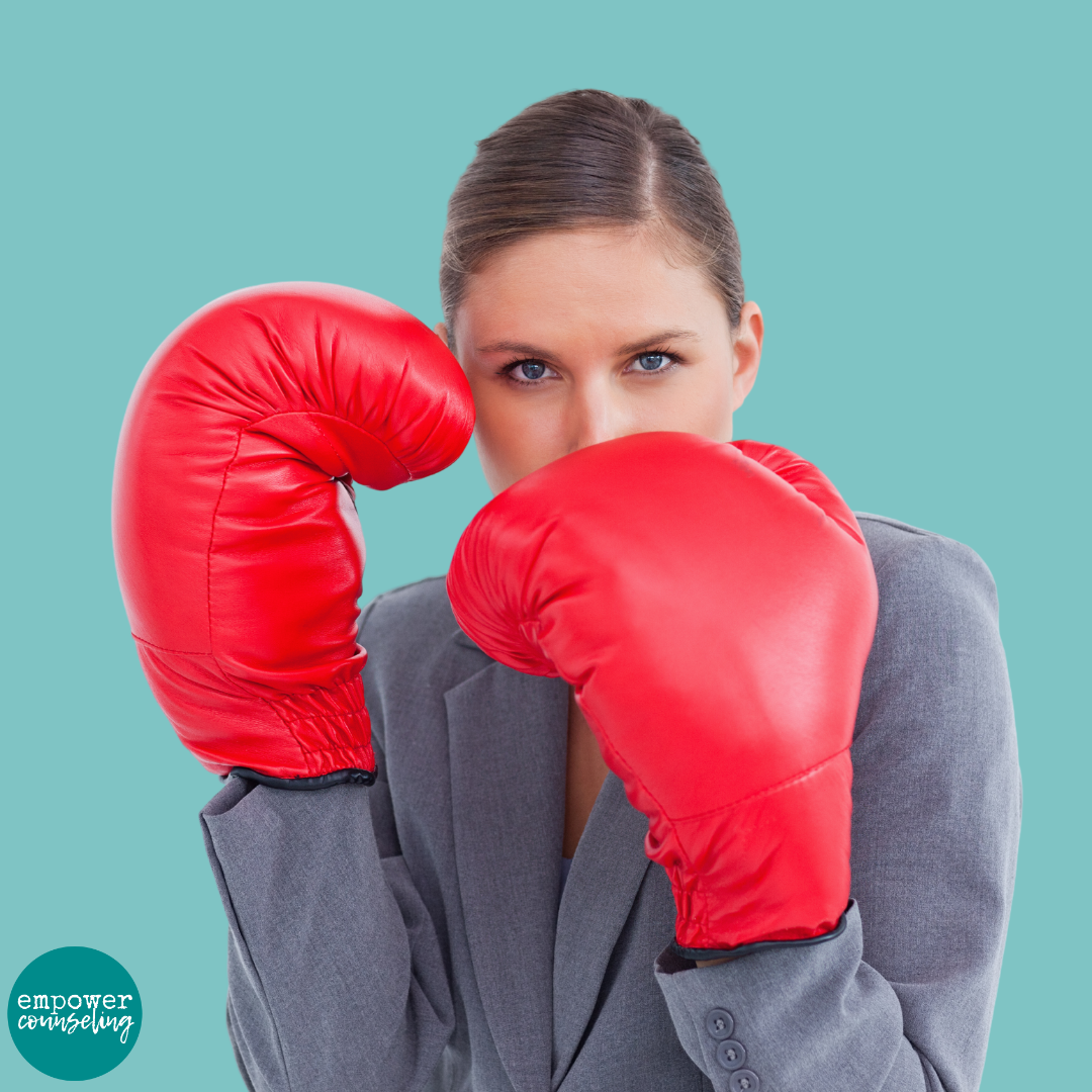 illustration of defensiveness showing an image of a woman with boxing gloves up, ready to fight