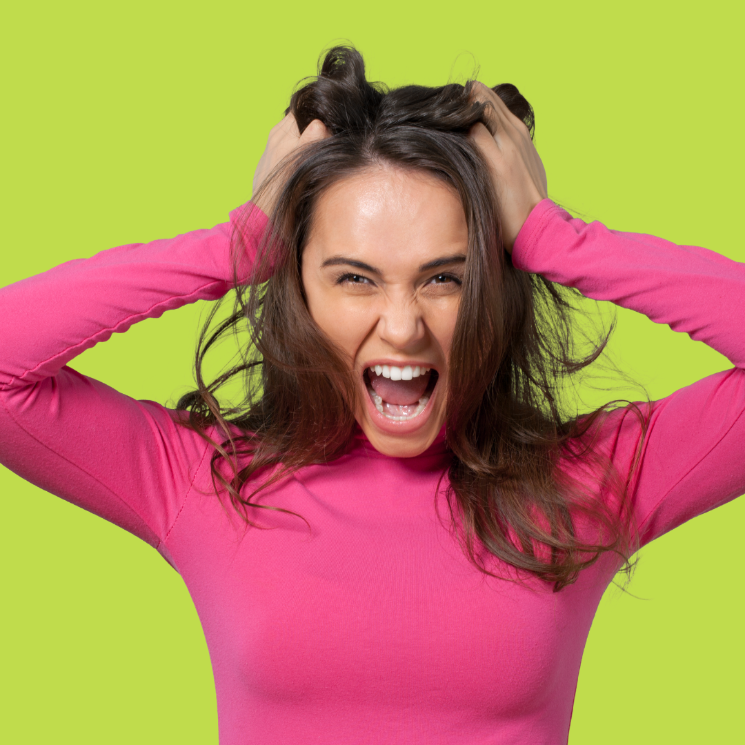 Why do I sabotage myself? Woman pulling her hair in frustration—visual representation of self-sabotage and nervous system overwhelm. Empower Counseling, trauma therapy for overachievers.
