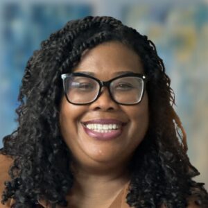 Traci Gordon, intern therapist specializing in burnout and overthinking, smiling in a professional headshot.
